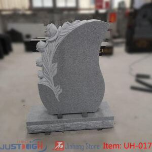 upright granite headstone with flower carving