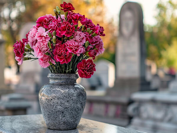 a_bouquet_of_carnations_placed_in_a_gravestone